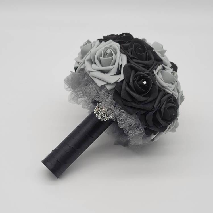 Black and gray bouquet made with real touch roses. Rhinestones on every rose. Gray tulle underneath. Silver brooch and black satin ribbon.