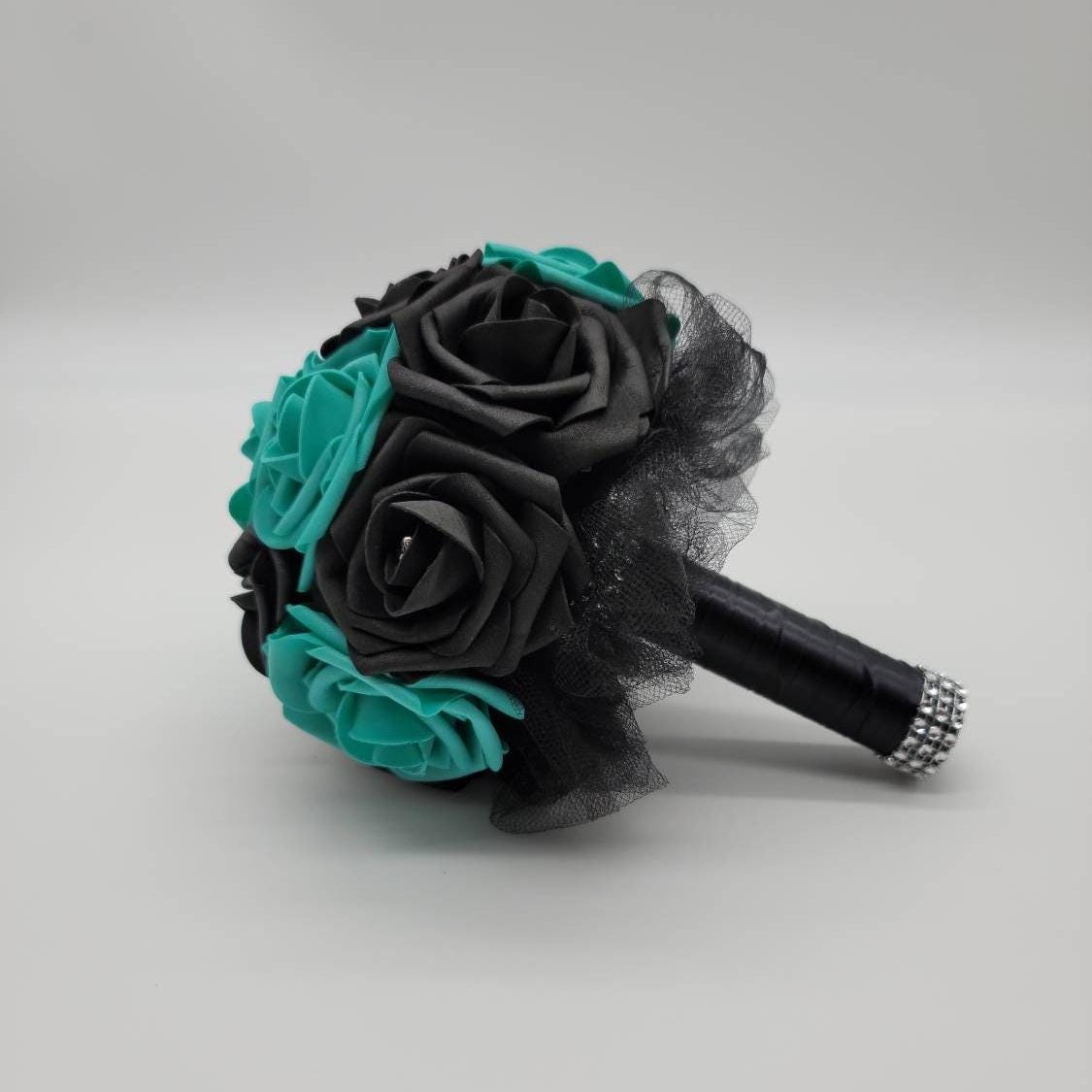 Black and teal bouquet with black tulle, black satin ribbon. Silver bling wrap. rhinestones on every rose.