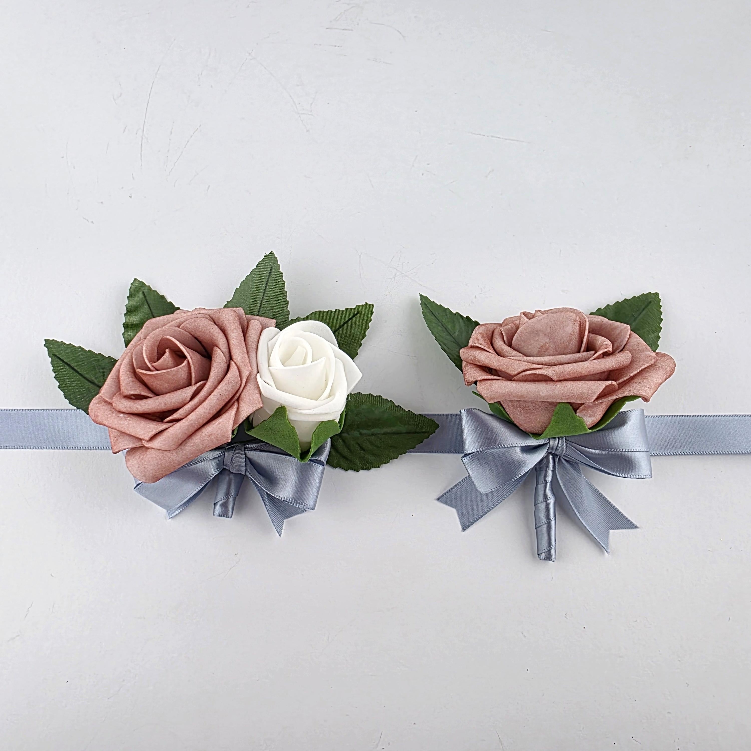 Dusty rose and white wrist corsage and dusty rose and dusty blue boutonniere