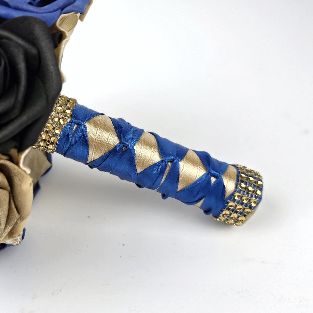 Handle is made up of royal blue and gold ribbon with gold bling wrap