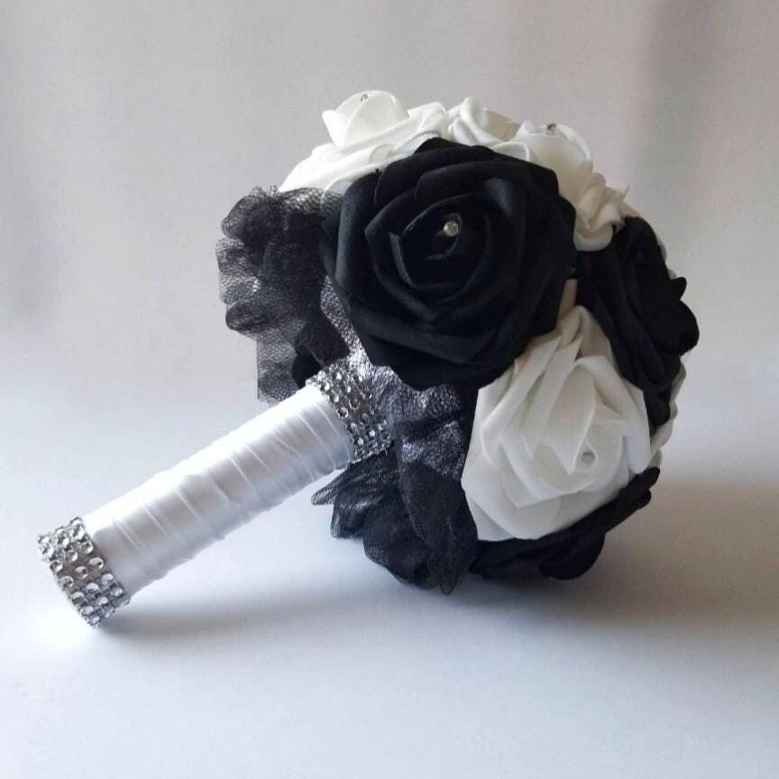 black and white bouquet with rhinestones on every rose. Handle is made up of black tulle and white satin ribbon and finished with a silver bling wrap.