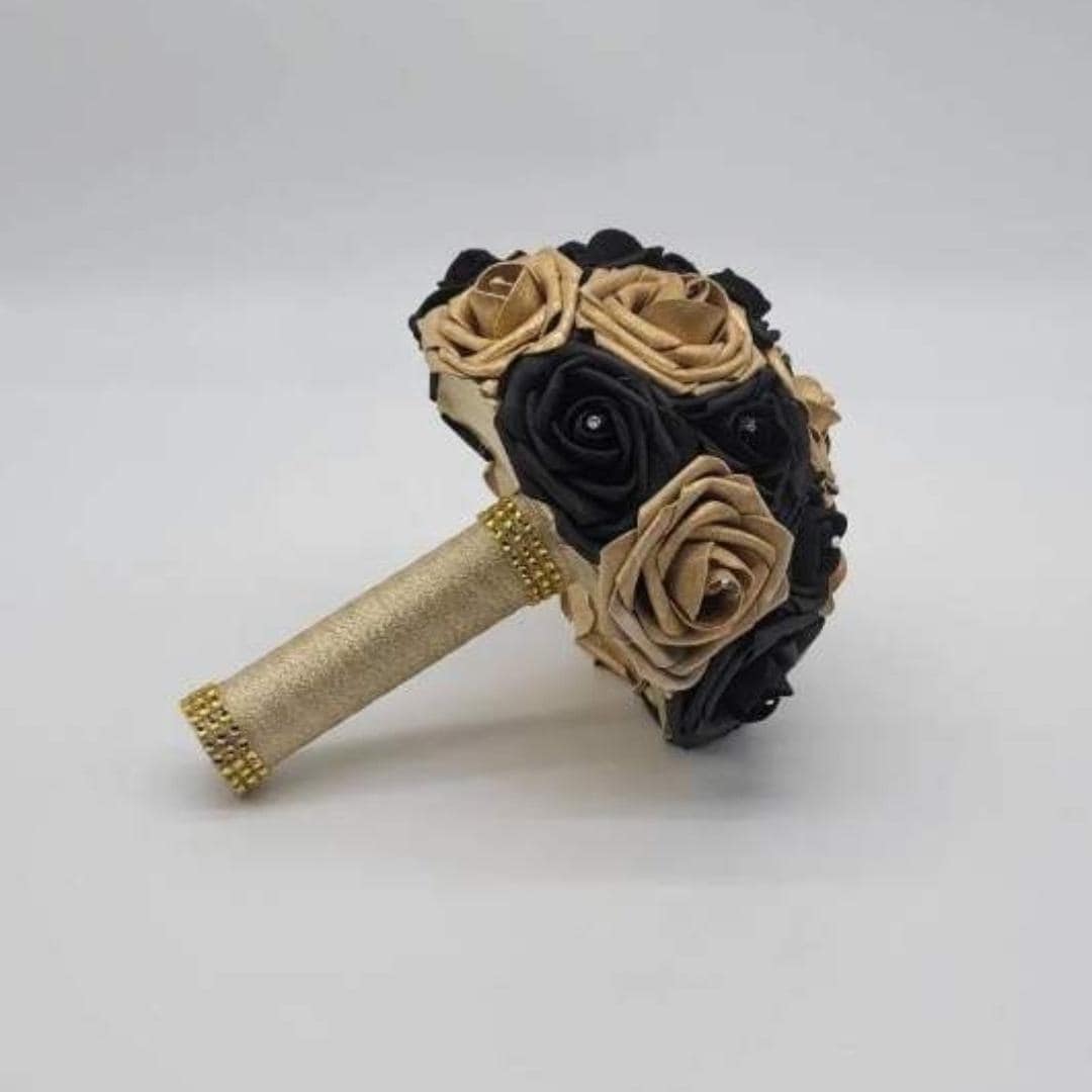 black and gold bouquet side view with gold ribbon and bling wrap