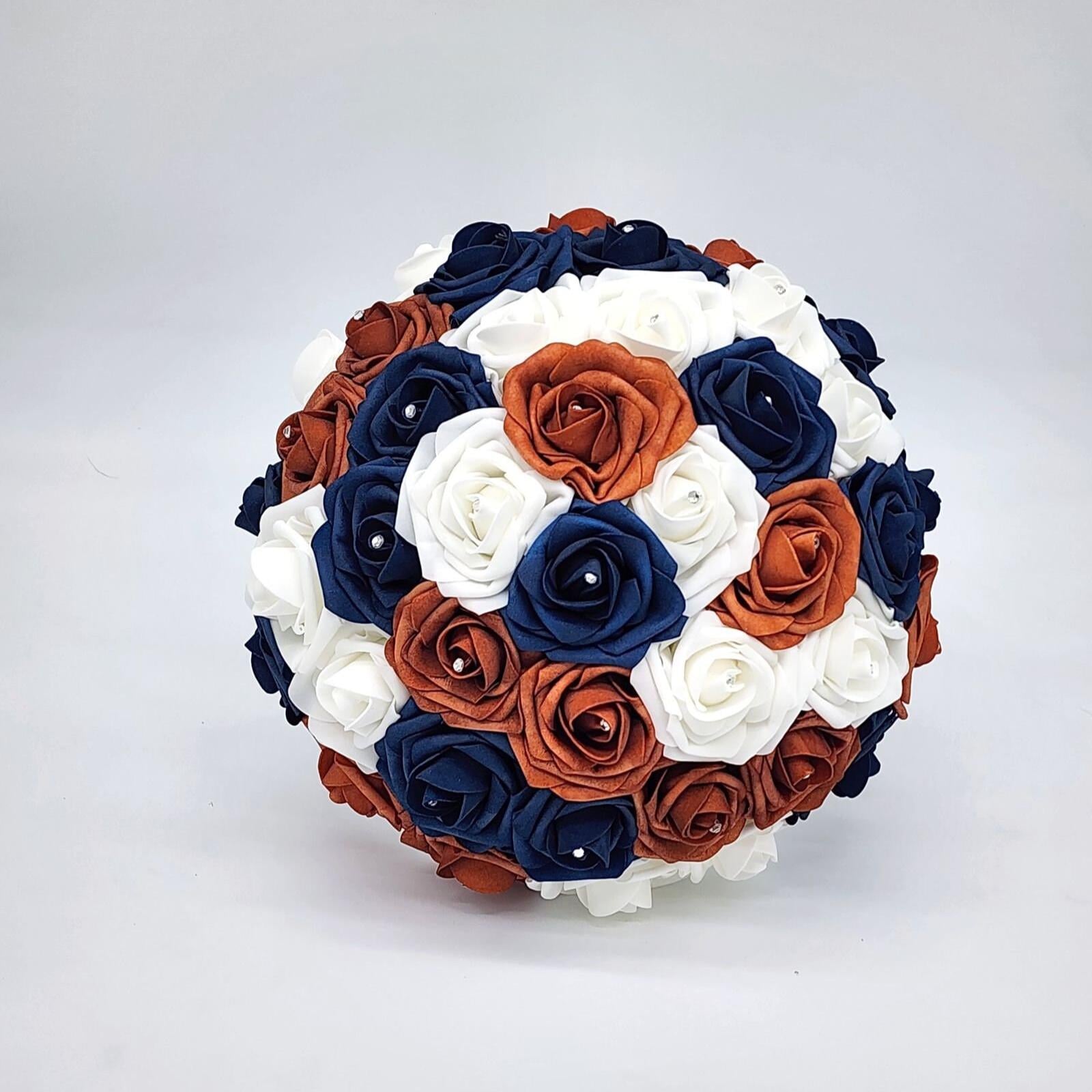 Burnt orange, navy, and white round bridal bouquet with rhinestones on every rose.