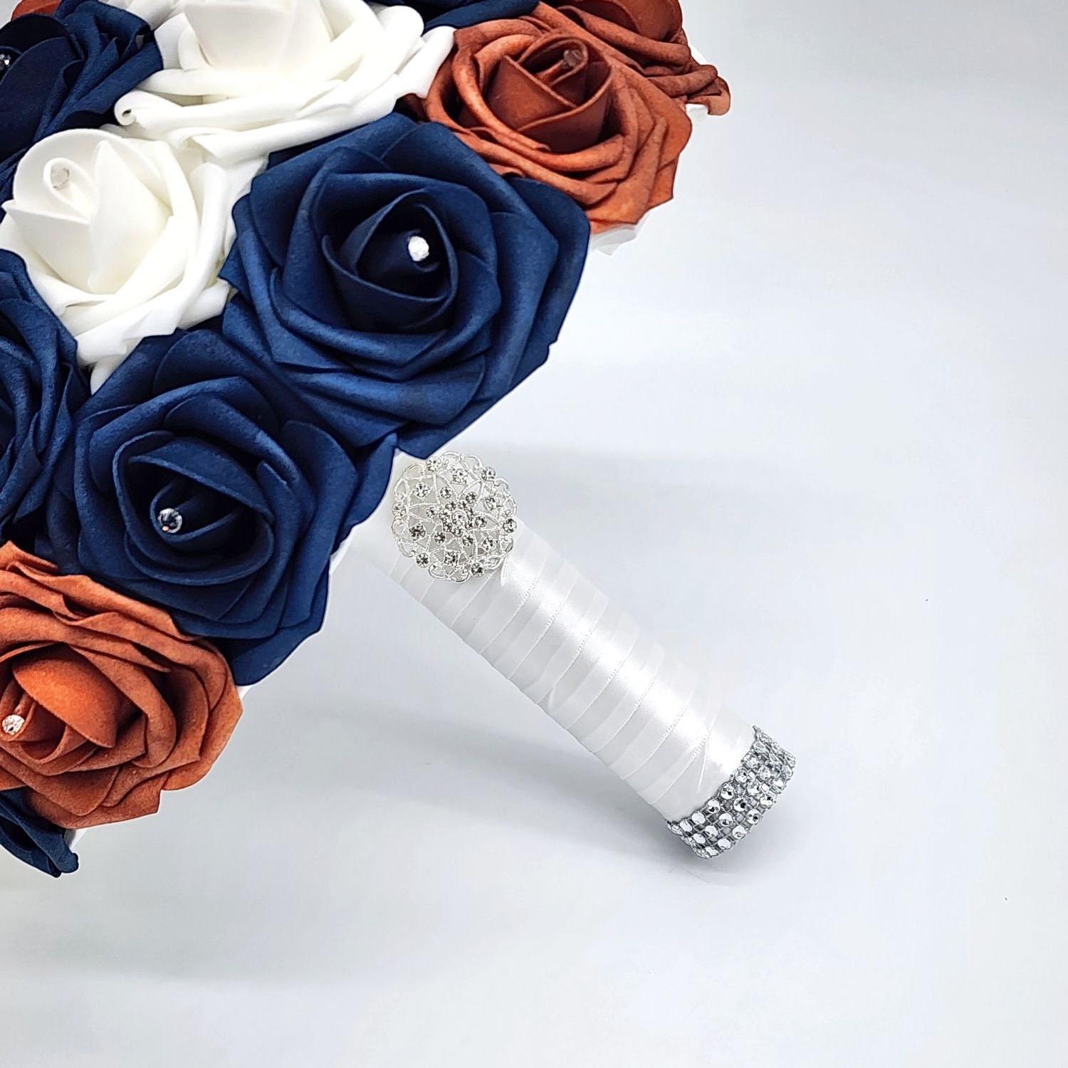Handle is made up of white satin ribbon with silver brooch and bling wrap.