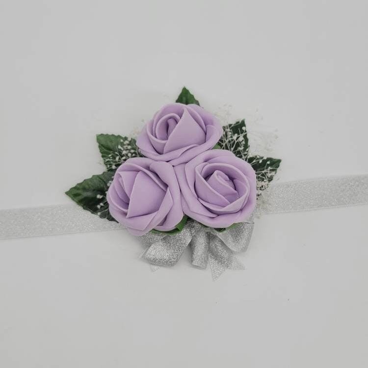 Lilac wrist corsage with baby's breath with silver ribbon