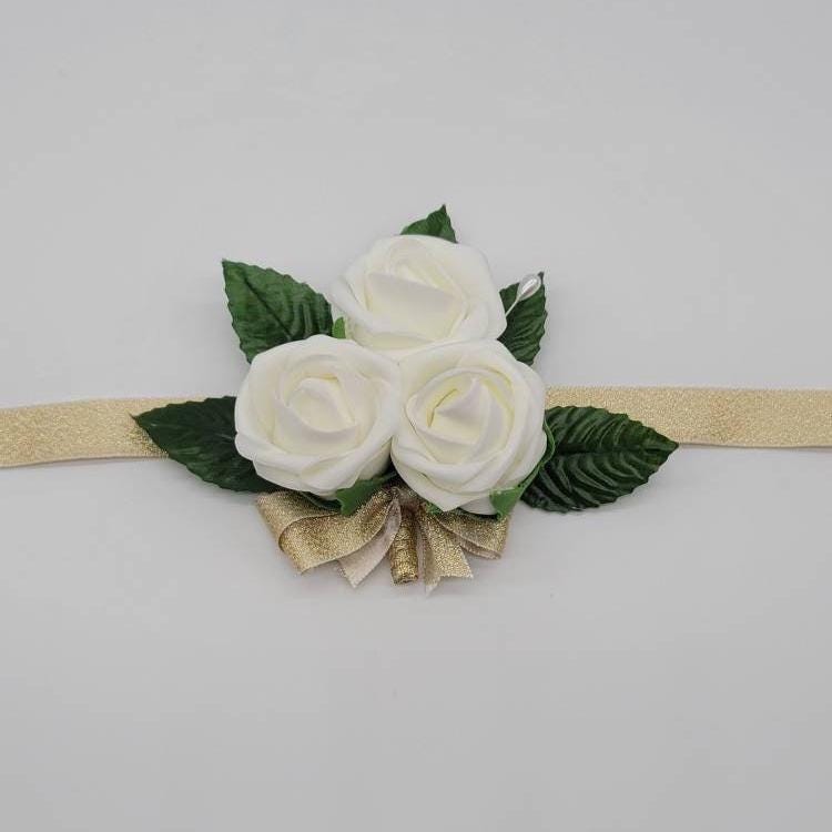 Ivory and gold wrist corsage