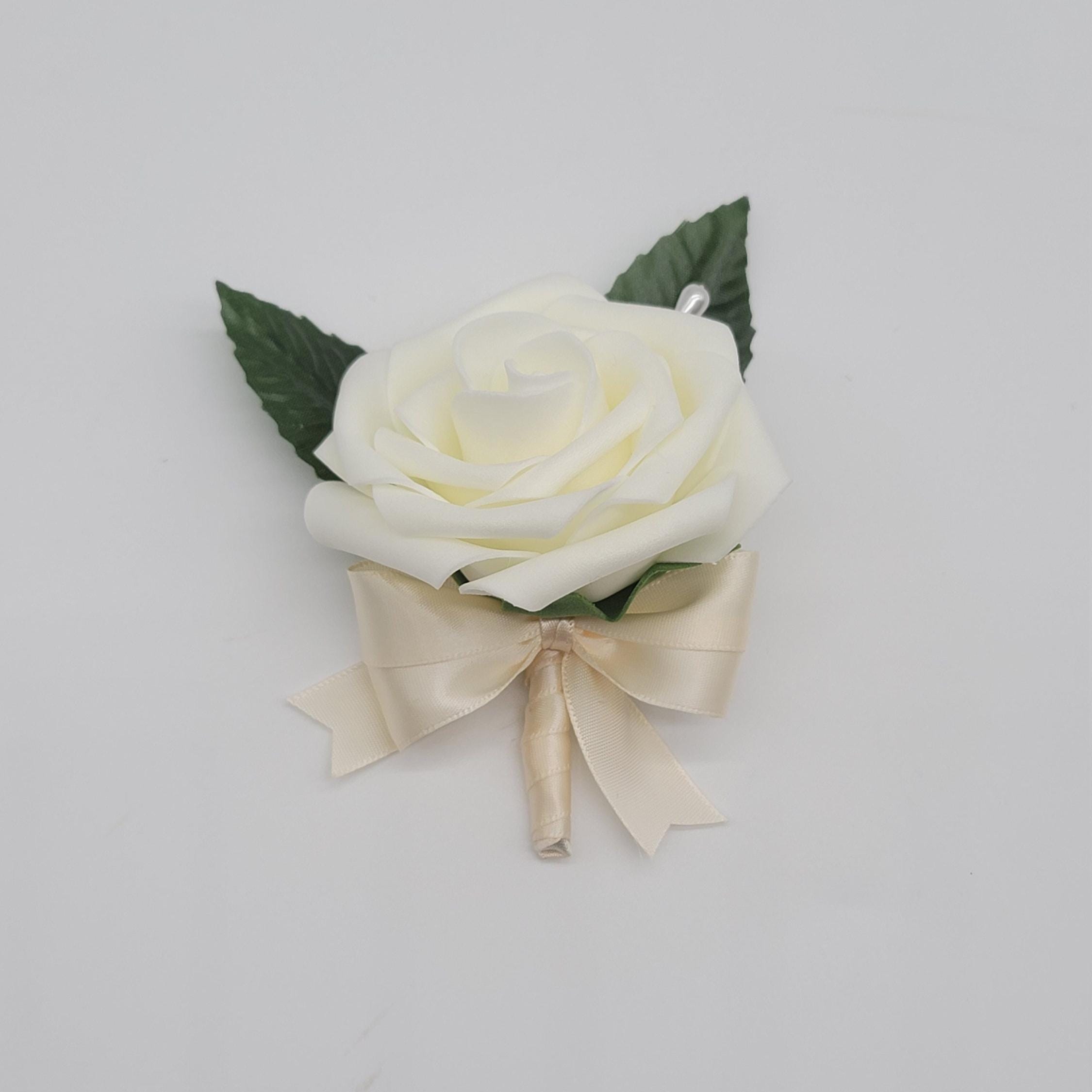 ivory boutonniere with ivory ribbon
