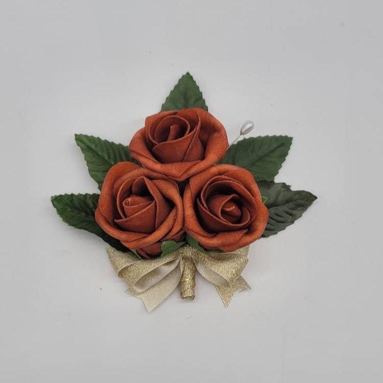 burnt orange and gold pin on corsage