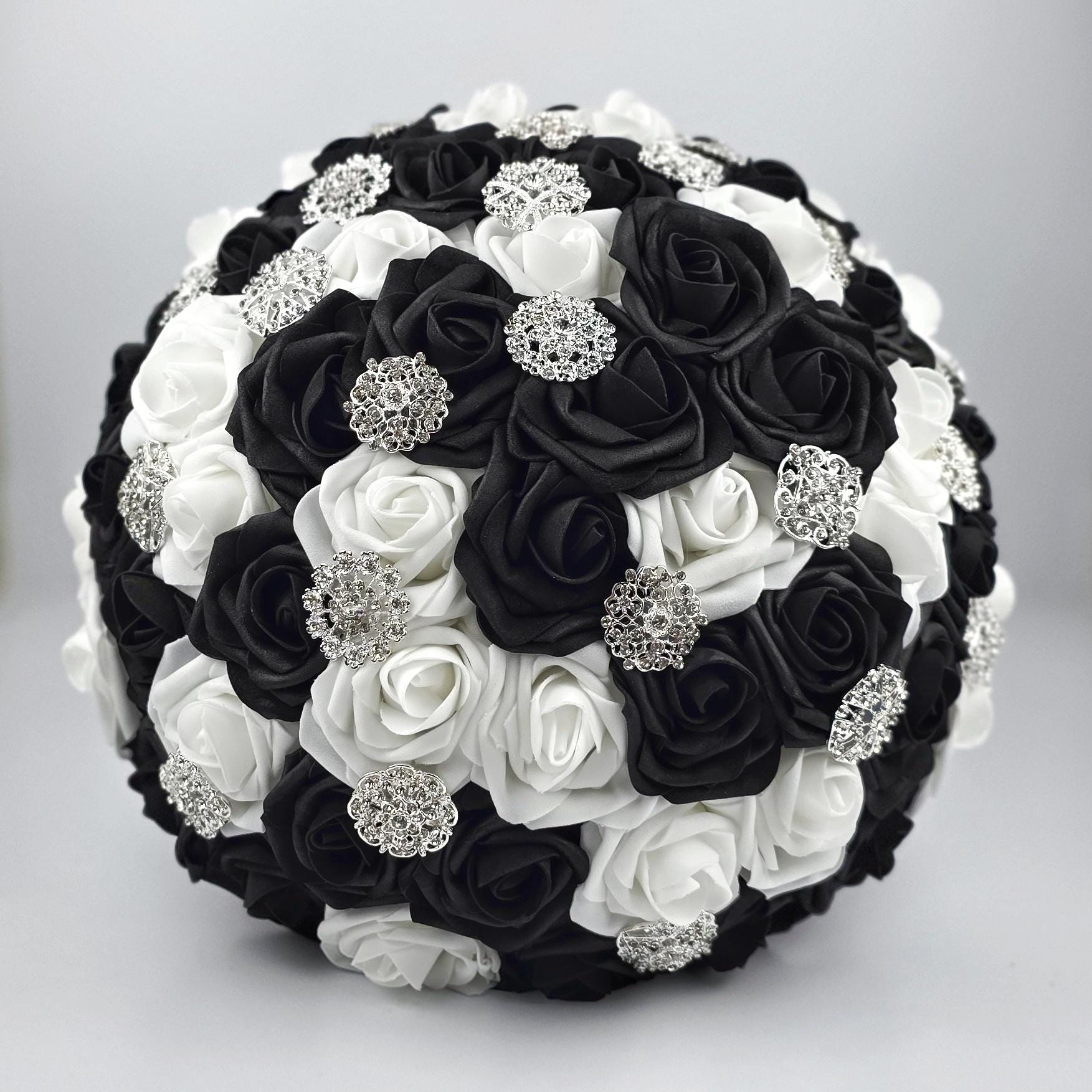 Black and white bouquet front with silver brooches.