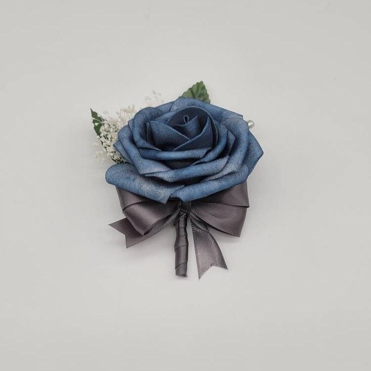 Dusty blue boutonniere with gray ribbon and baby's breath