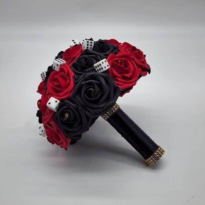 Red and black Las Vegas Bouquet with rhinestones, card suits and dice scattered throughout. Handle is made up of black satin ribbon and finished with gold bling wrap